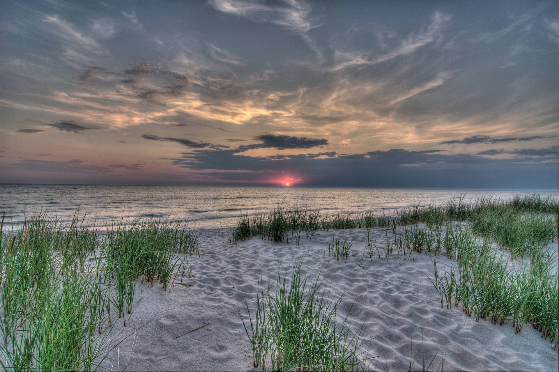 Lake Michigan shoreline at sunset with dune grass