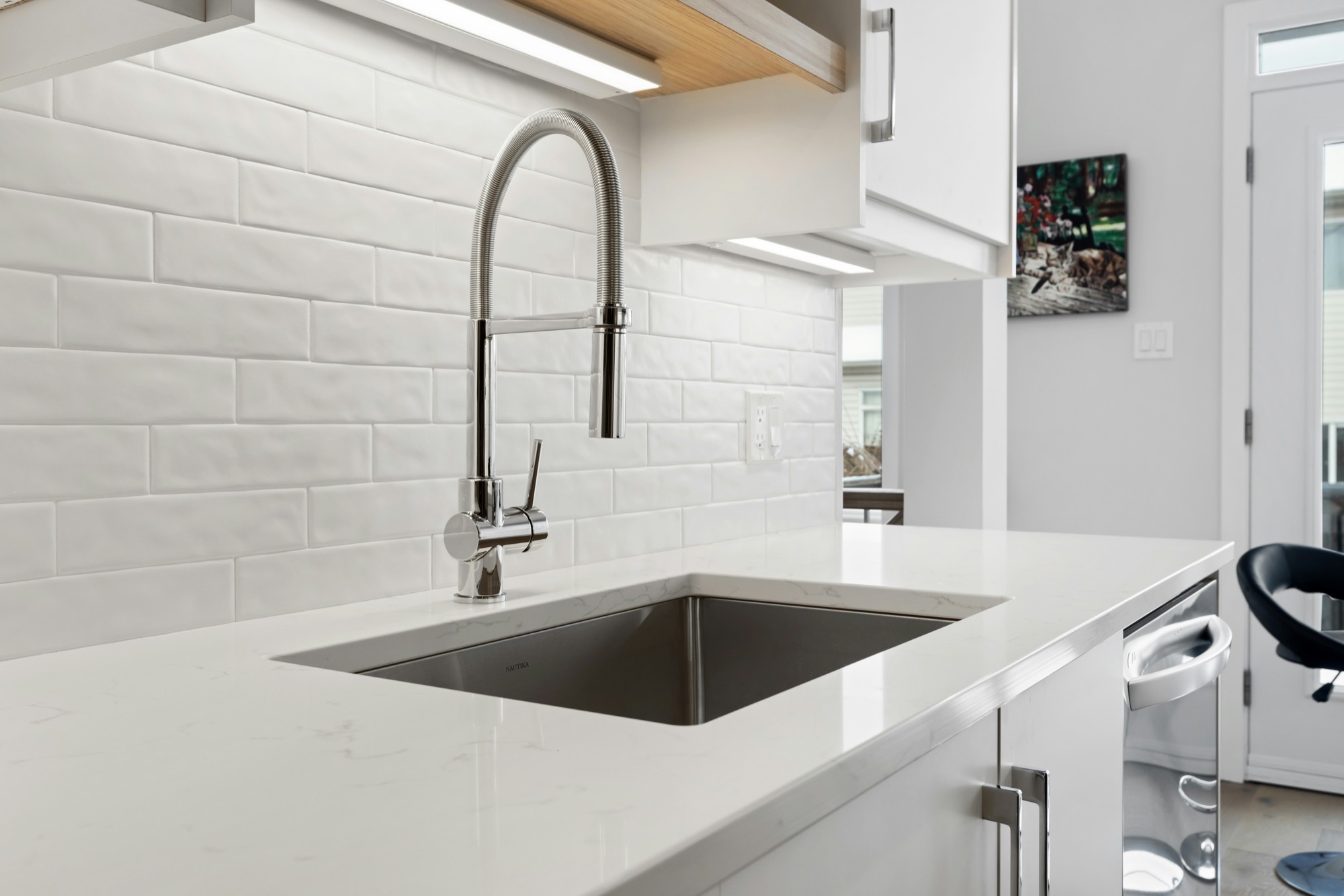 Bright kitchen sink with a stainless steel faucet